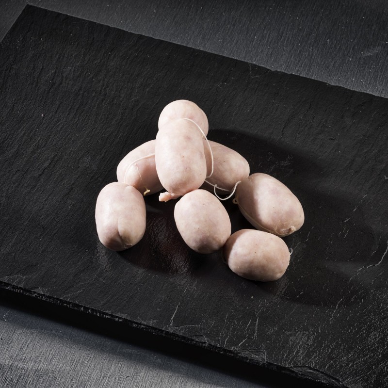 Butifarra blanca cruda sobre pizarra negra, ideal para recetas tradicionales